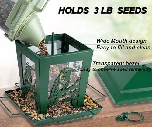 Green bird feeder with seeds being poured in.