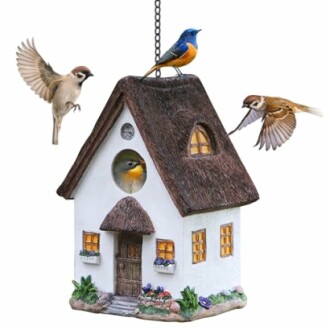 Decorative birdhouse with three birds perching and flying around.