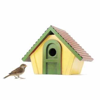 A sparrow next to a yellow and green birdhouse with a brown roof.