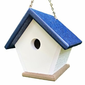 White birdhouse with a blue roof hanging on a chain.