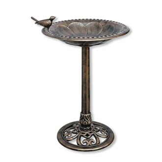 Bronze bird bath with bird ornament and decorative stand