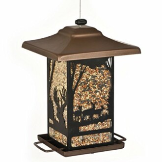 Bronze bird feeder with wildlife silhouettes and seed inside.