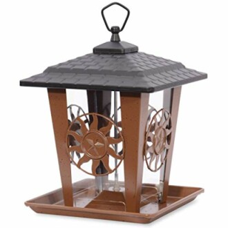 Decorative bird feeder with metal roof and star design.