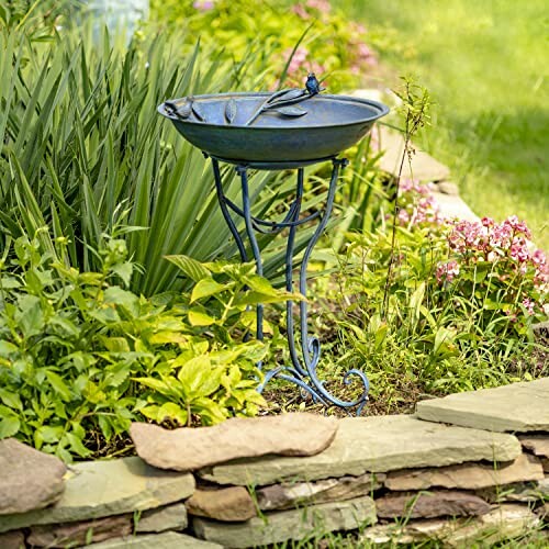 Garden bird bath with flowers and greenery