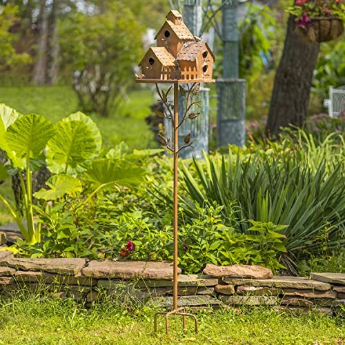 Wooden birdhouse on a tall stand in a garden