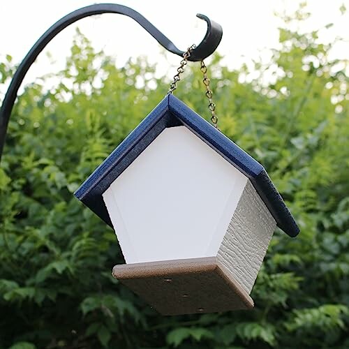 Small hanging birdhouse with blue roof