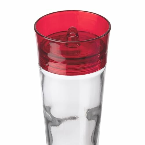 Clear tumbler with red lid showcasing the feeder's design