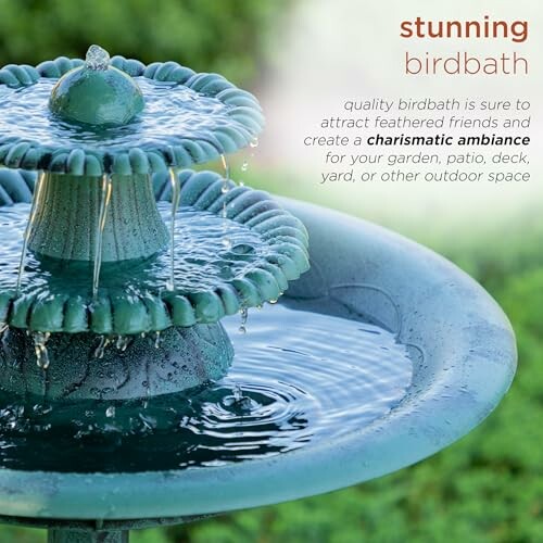 Green two-tier birdbath with water cascading.