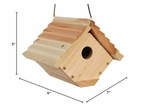 Wooden birdhouse with dimensions labeled.