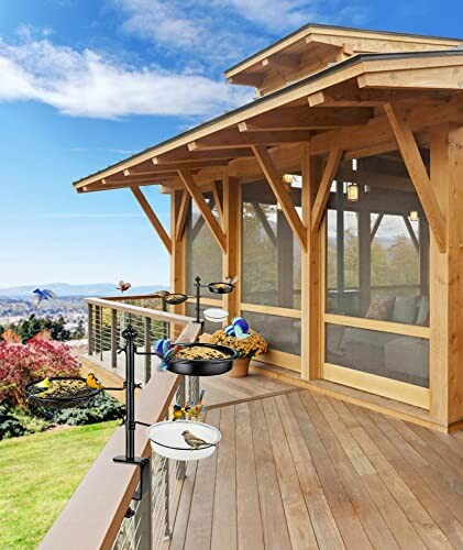 Wooden deck with bird feeders and scenic view